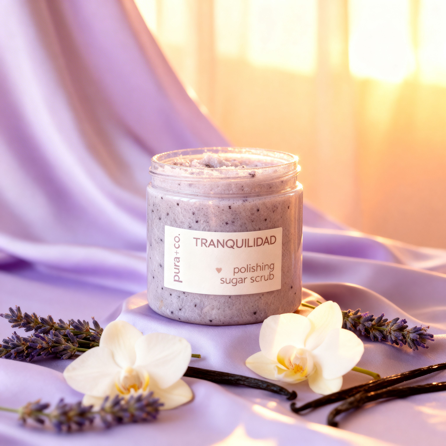 Pura+Co | Tranquilidad Sugar Scrub sits open on a lavender surface, cap open highlighting the ingredients | Exfoliante Natural |  Lavender Vanilla Scent | Handmade Skin Care | Vegan | Puerto Rico