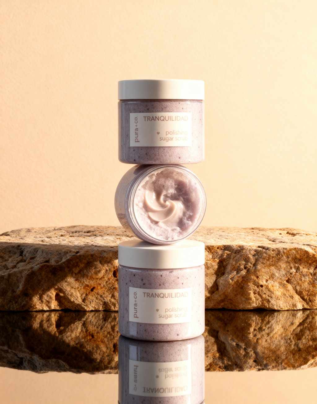 Pura+Co | A column of three Tranquilidad Sugar Scrubs sits on top of each other on a reflective surface | Exfoliante Natural |  Lavender Vanilla Scent | Handmade Skin Care | Puerto Rico