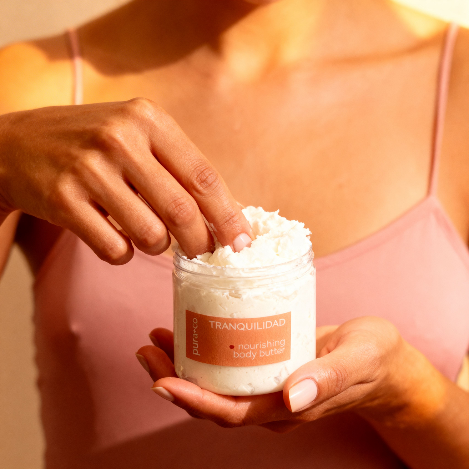 Pura+Co | The Tranquilidad body butter jar  is showcased in a woman's hands | Lavender and Vanilla Scent | Handmade Skin Care | Puerto Rico