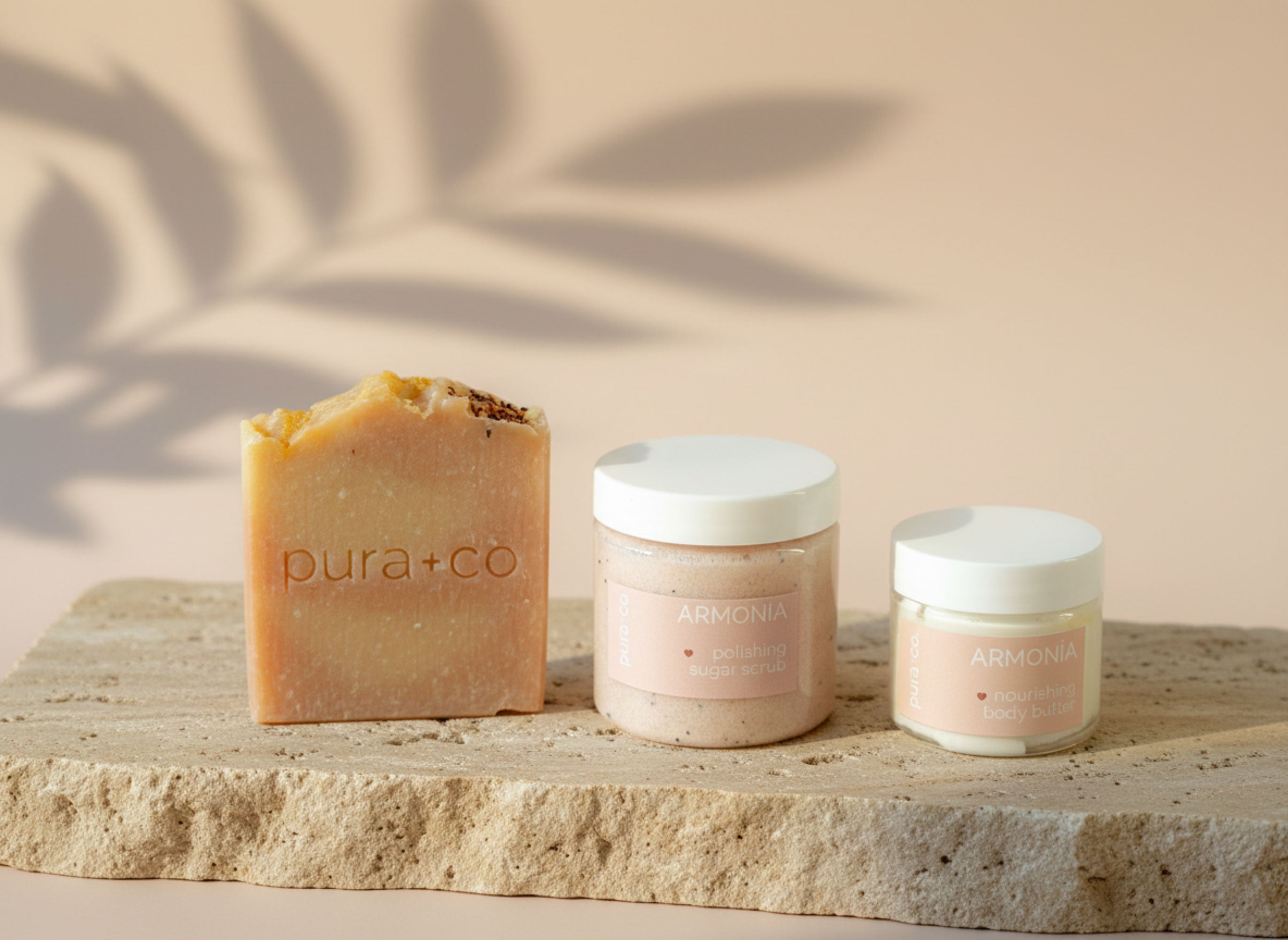 Soap bundle Pura+Co | Soap Bar, Sugar Scrub jar, & Body butter jar sample appear on a flat stone surface. Handmade Skin Care | Puerto Rico